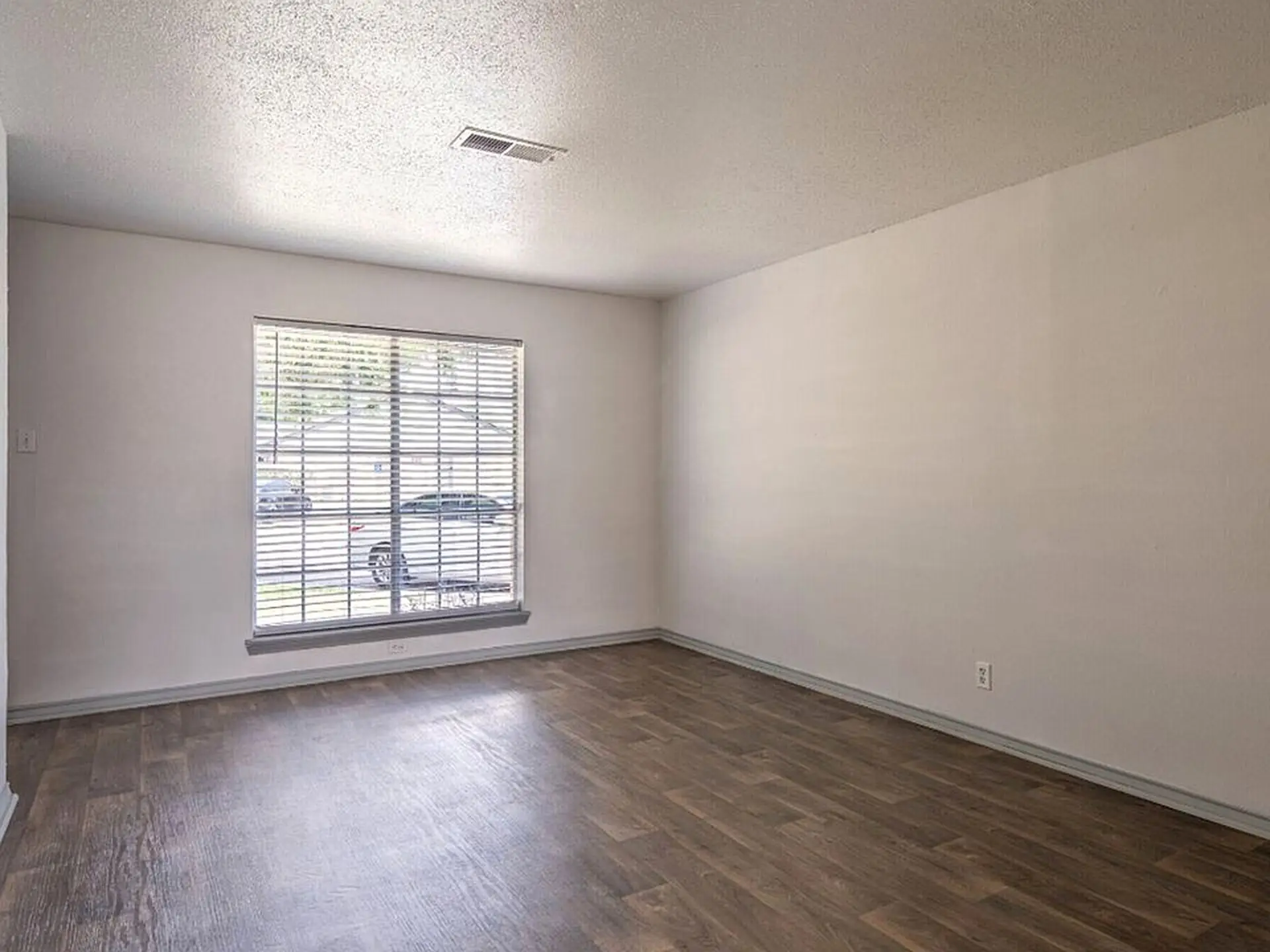 Light-filled flex room with wood floors